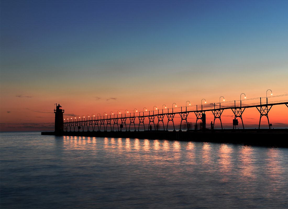 South Haven, MI - Sunset on Lake Michigan with Pier and Lighthouse in Distance